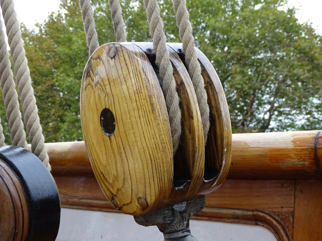 Wooden block and tackle on a ship's deck.
