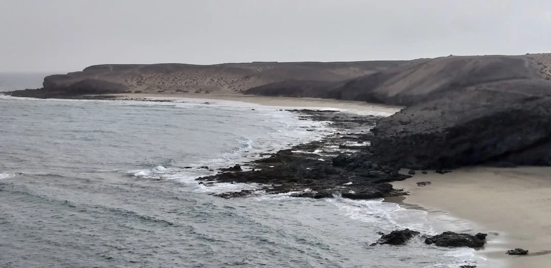 Volcanic Canary Island rising from the Atlantic Ocean with rugged coastline