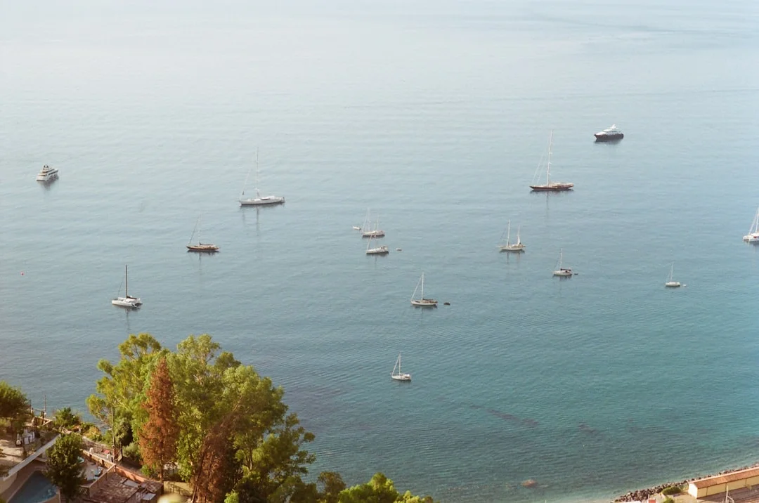 Sailboats floating on a calm Mediterranean sea