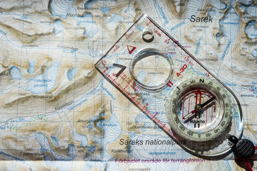 Compass and parallel ruler on a nautical chart used in navigation certification courses