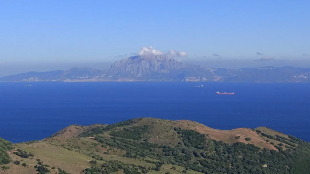 View of the Strait of Gibraltar from Spain looking towards Africa with ocean waters and distant mountains