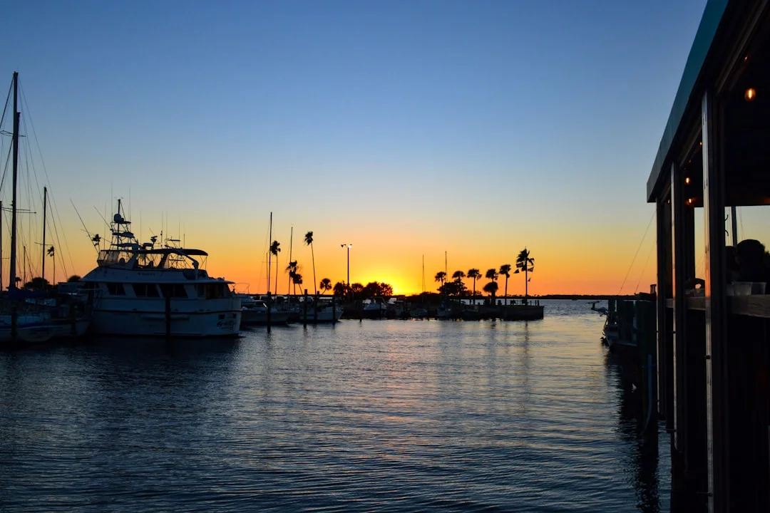 Sailboats docked at a Florida marina at sunset