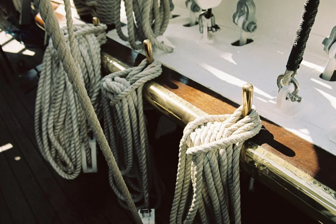 Sailing ropes coiled on a boat deck, demonstrating proper rope management for sailing knots
