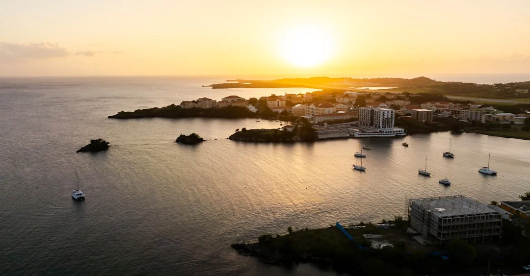 Caribbean coastal town with boats at sunset