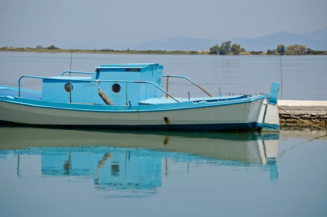 White cruising catamaran sailing on blue water