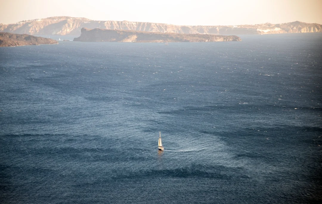 Sailboat turning on the open Aegean Sea near the Greek islands