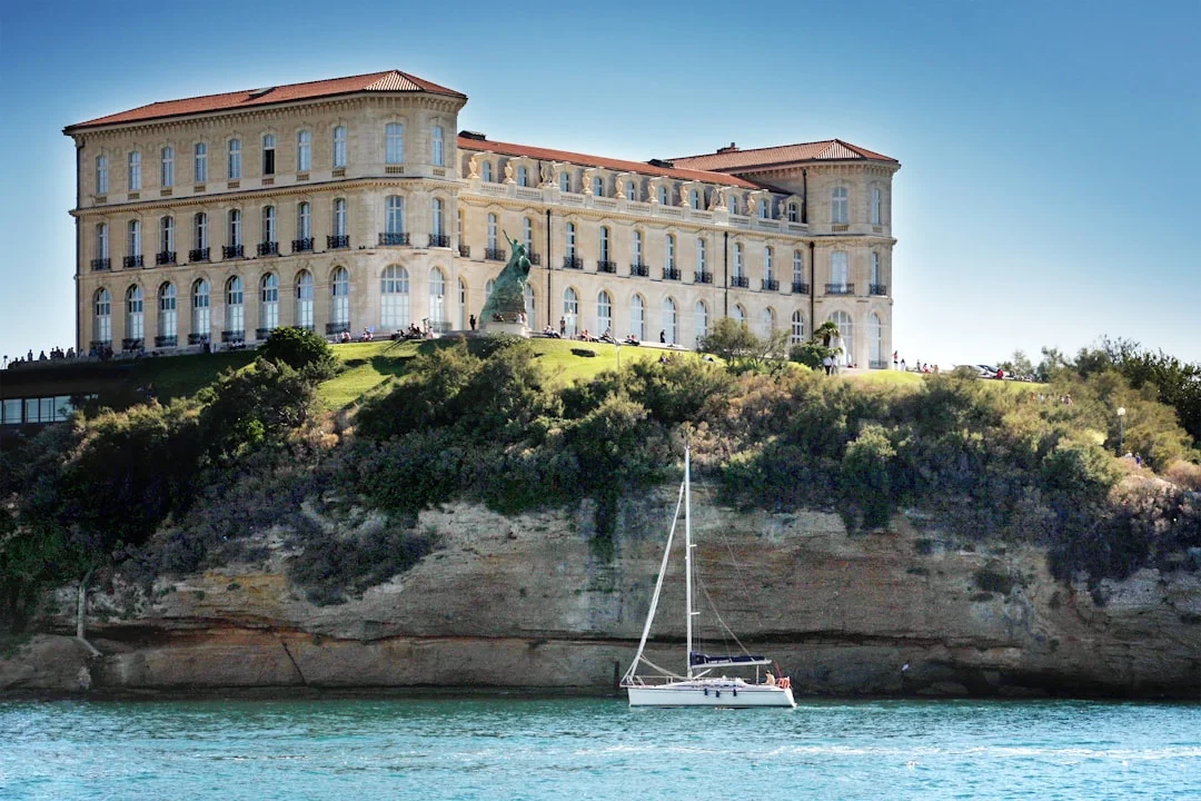Sailboat gliding past the Palais du Pharo in Marseille, France on the Mediterranean