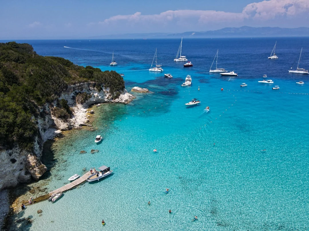 Aerial view of turquoise waters and a yacht anchored near Antipaxos in the Ionian Islands