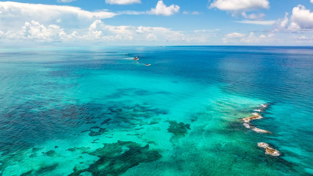 Aerial view of the turquoise Bahamian ocean with boats