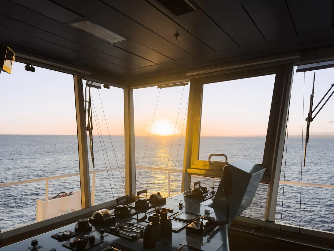 Golden sunset over the ocean seen from a sailboat cockpit