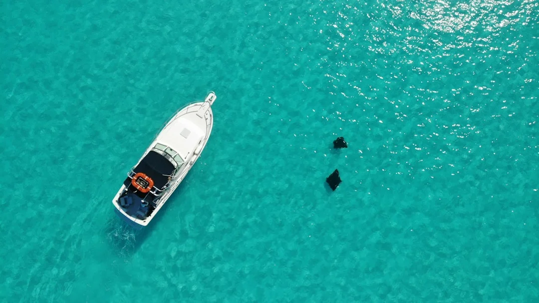 Couple relaxing on a charter catamaran in clear turquoise water