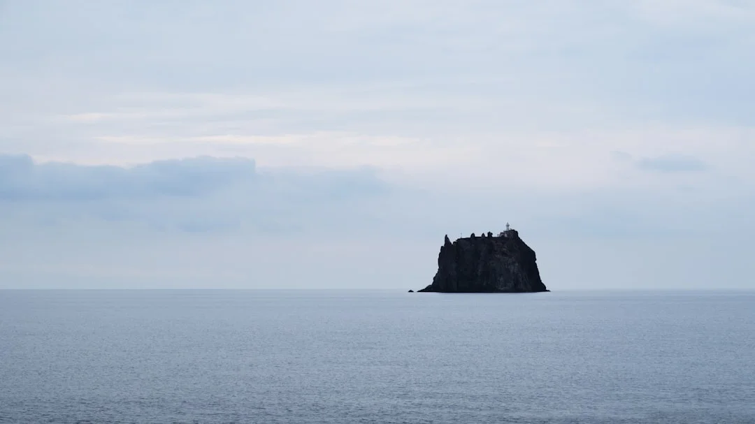 The volcanic rock formation of Strombolicchio rising from the sea in the Aeolian Islands, Sicily