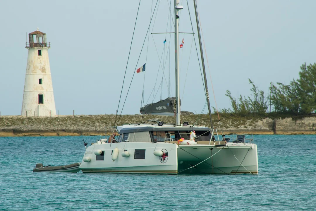 Catamaran with sails down in Nassau Harbour showing wide beam and twin hull design