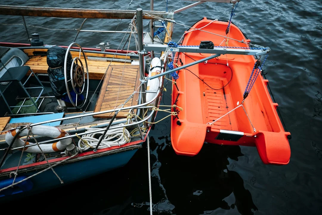 Sailing yacht equipped with orange lifeboat and safety equipment on open water