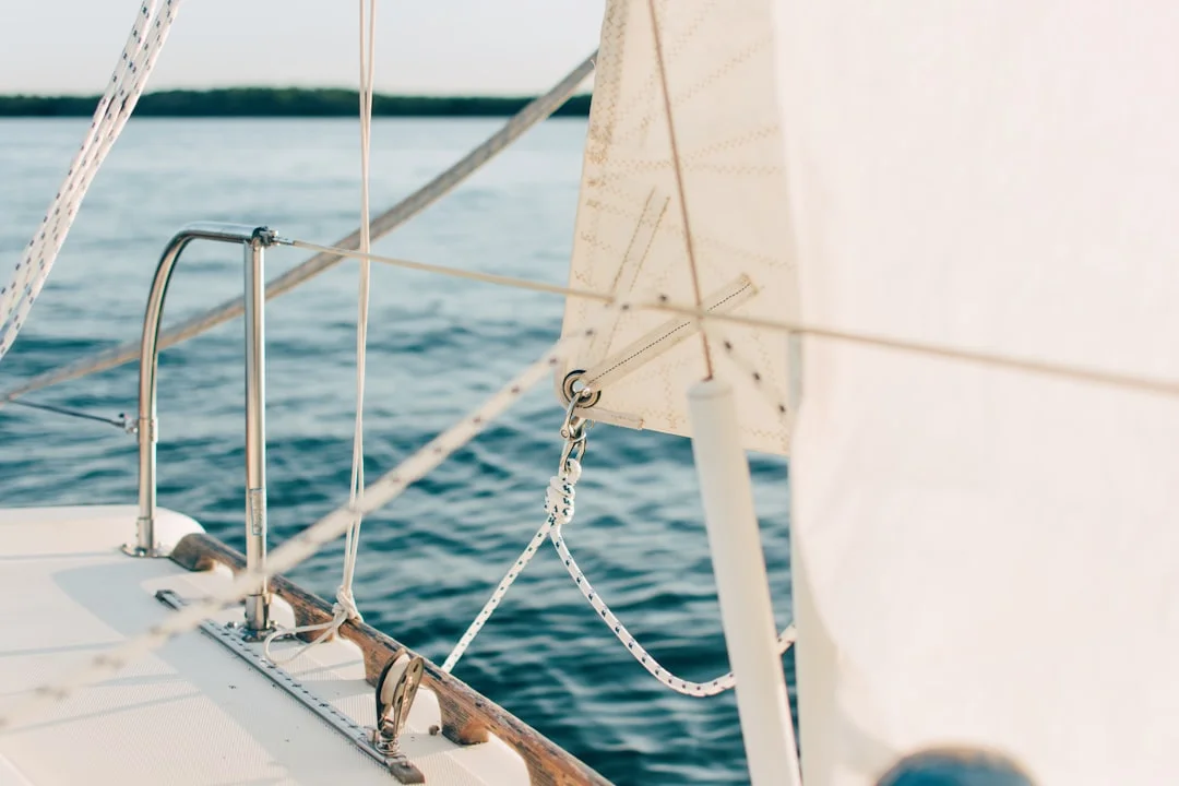 Bow view of a sailboat at anchor showing chain lead over the roller and a rigged snubber