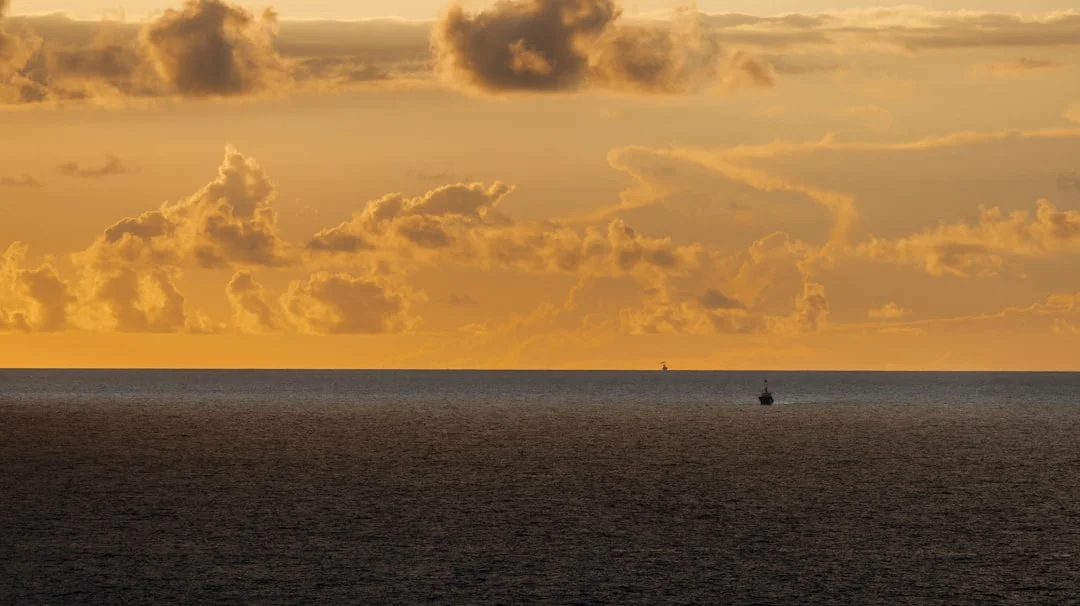 Golden sunset over a calm ocean horizon offering the clean reference line a sextant needs