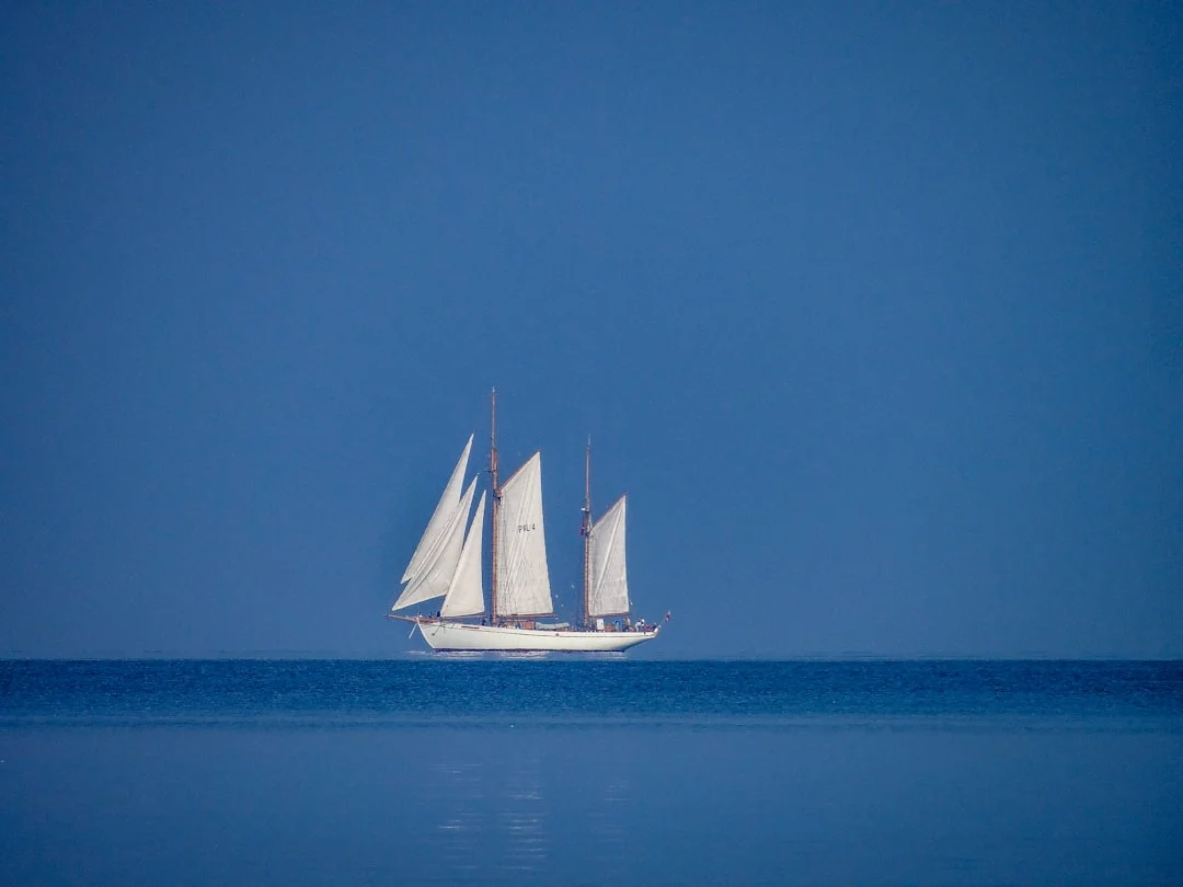 Sailboat alone on a large blue ocean during an offshore passage