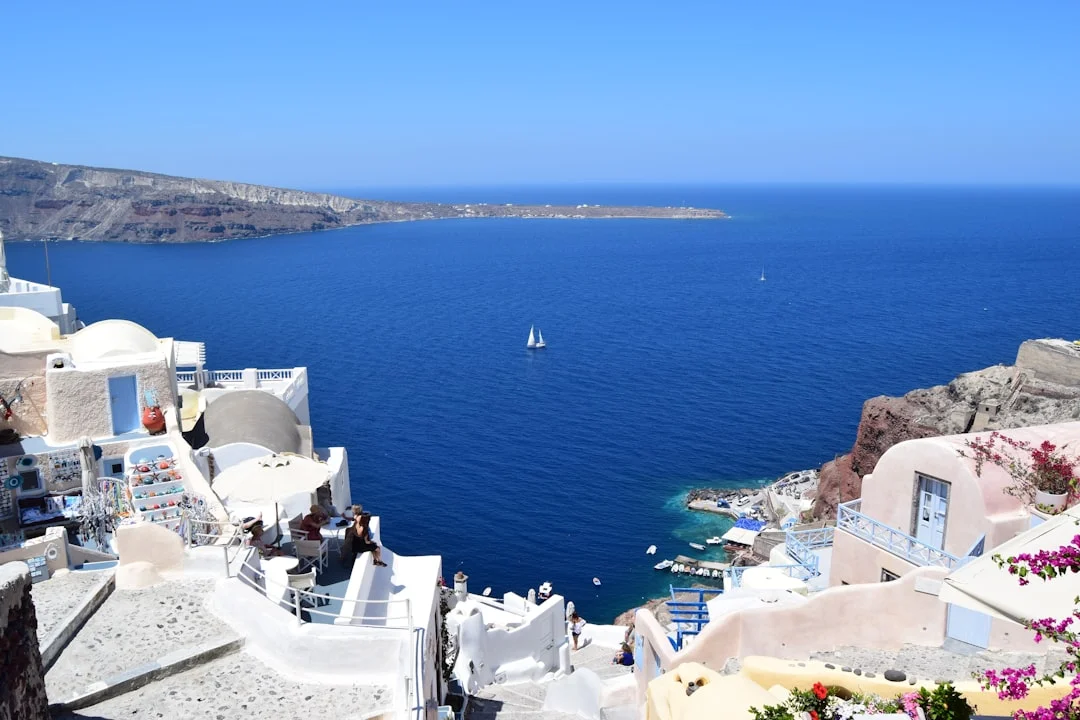 Whitewashed Santorini coastline above the sea