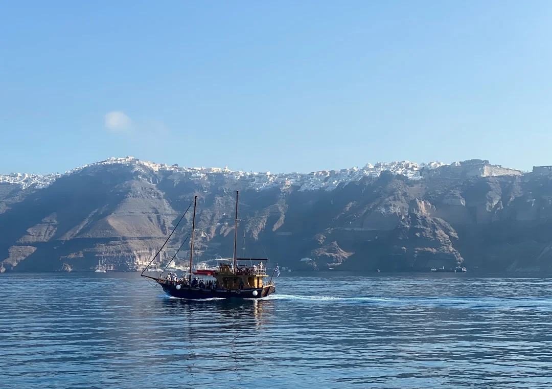 Sailboat near the volcanic caldera of Santorini