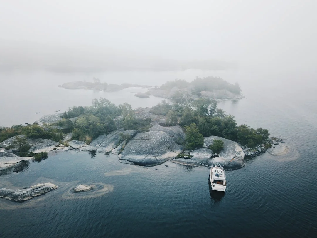 Aerial view of yachts moored among misty islands in the Stockholm archipelago