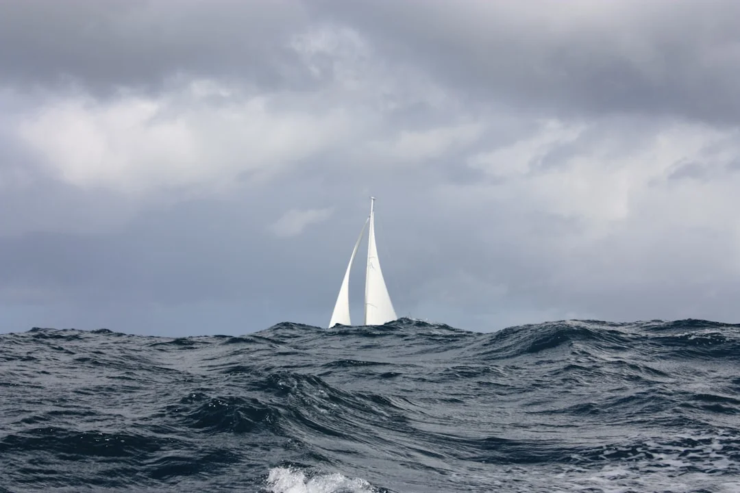 Sailboat in stronger wind under cloud cover