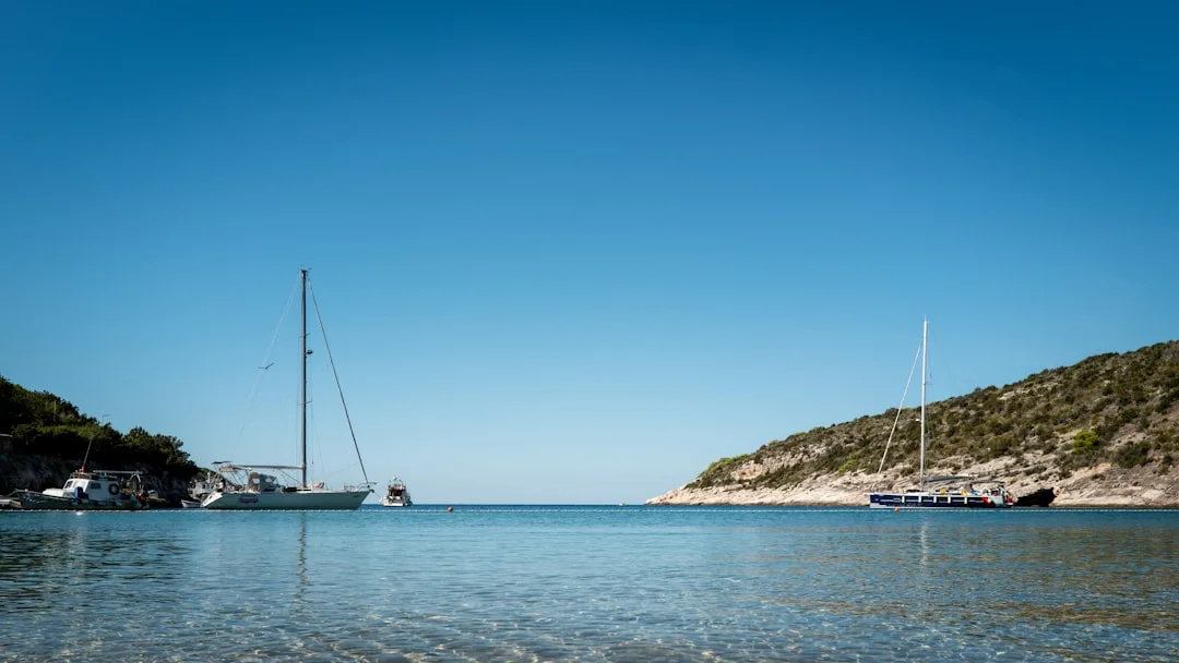 Affordable used sailboats anchored in a calm bay