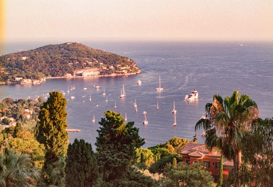 Aerial view of a yacht in a Corsica turquoise cove