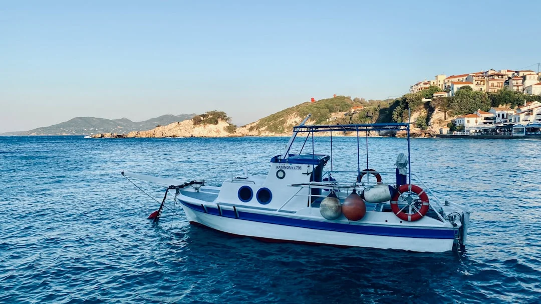 Sailing boat on the open Aegean Sea with Greek islands visible on the horizon