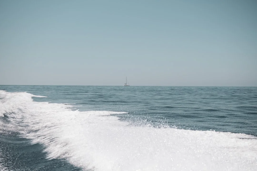 Meltemi-driven whitecaps in a Cyclades channel, with a reefed mainsail