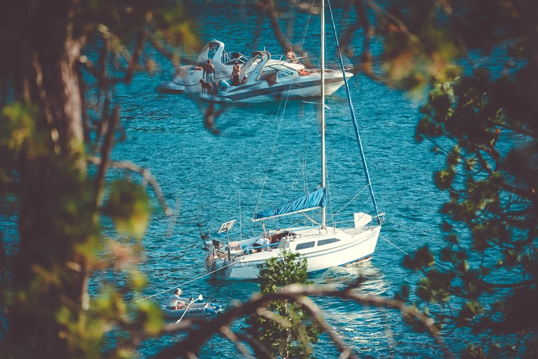 Sailboat anchored in a calm bay at sunset