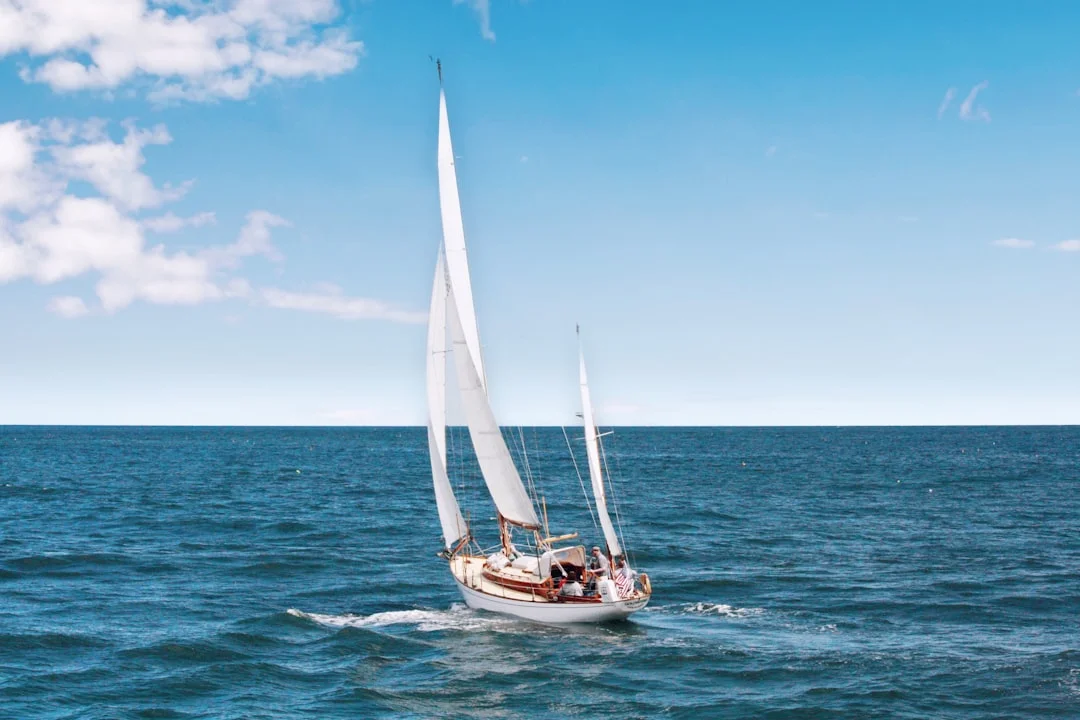 Racing yacht heeled over under full sail during a vintage yacht regatta