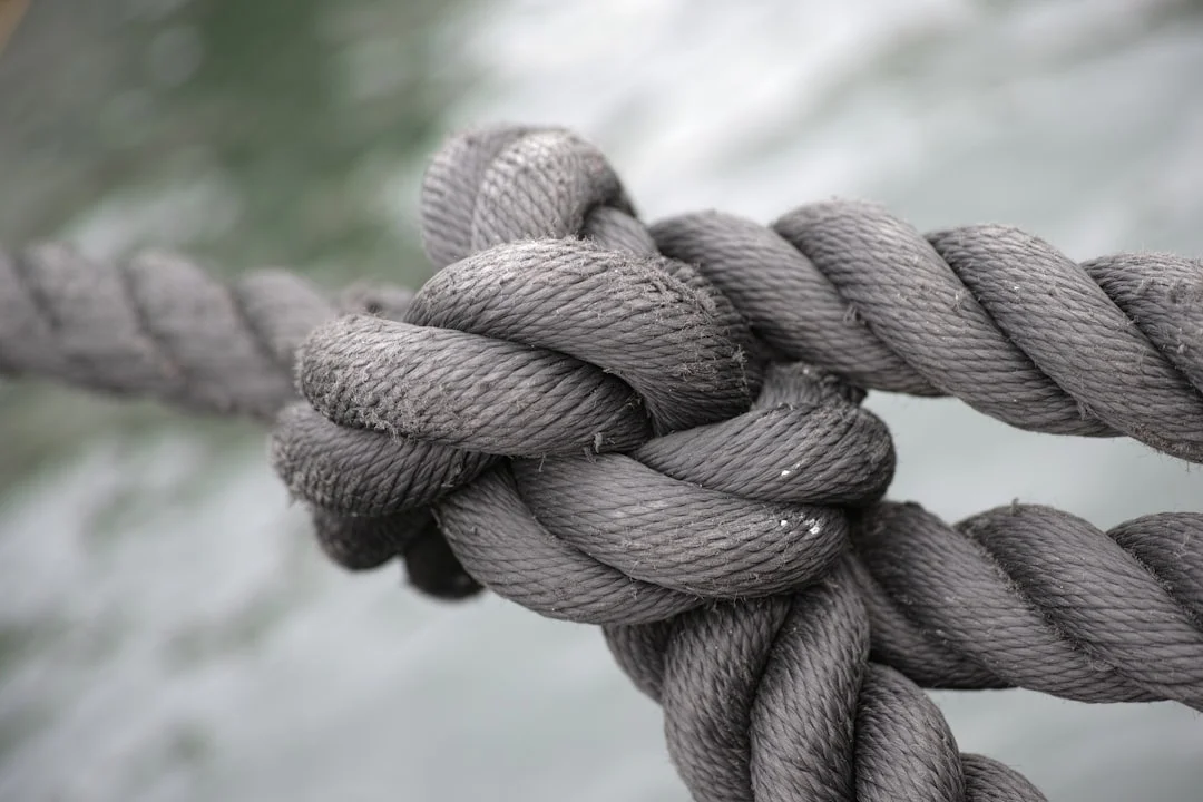 Sailing ropes coiled on a boat deck, demonstrating proper rope management for sailing knots