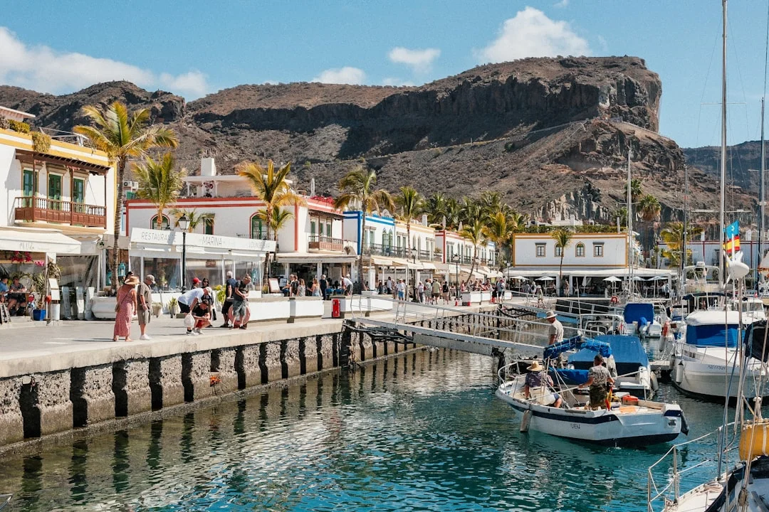 Marina harbor filled with sailing yachts beside a volcanic mountain in the Canary Islands