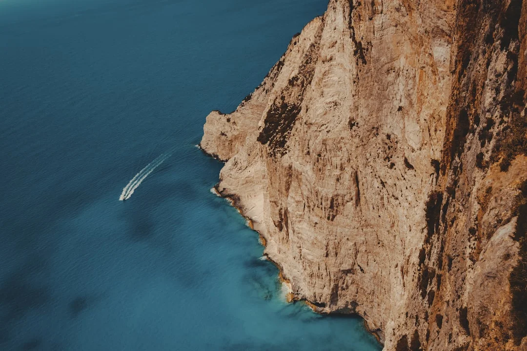 Calm Ionian anchorage with clear water and multiple boats on anchor