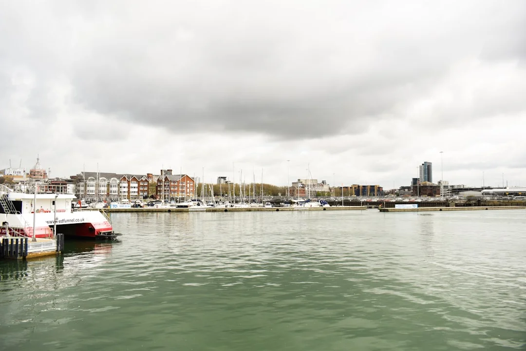 Sailboat departing Southampton Water past a Red Funnel ferry
