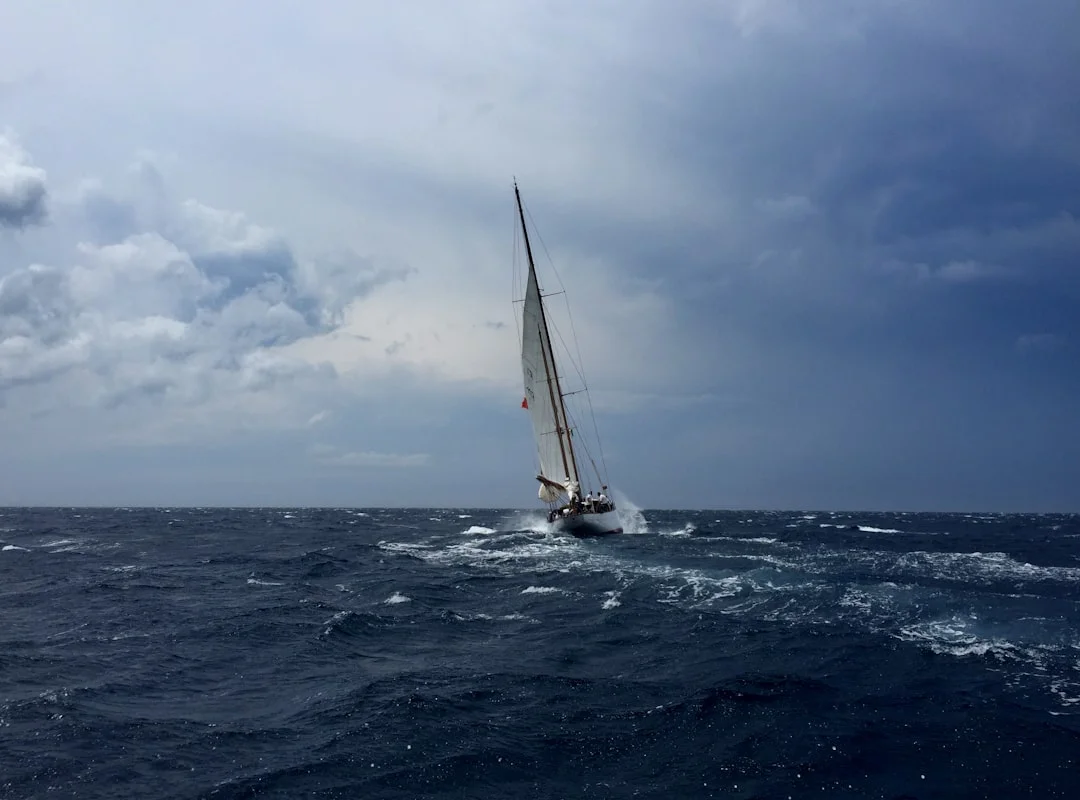 Sailboat hove-to with backed headsail and eased main, drifting slowly