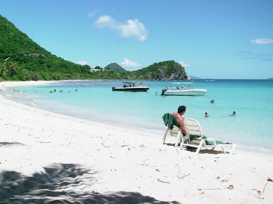 Dinghy landing at a BVI beach with surge visible near rocks