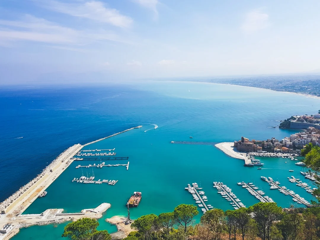 busy Italian marina office with price board and booking QR code