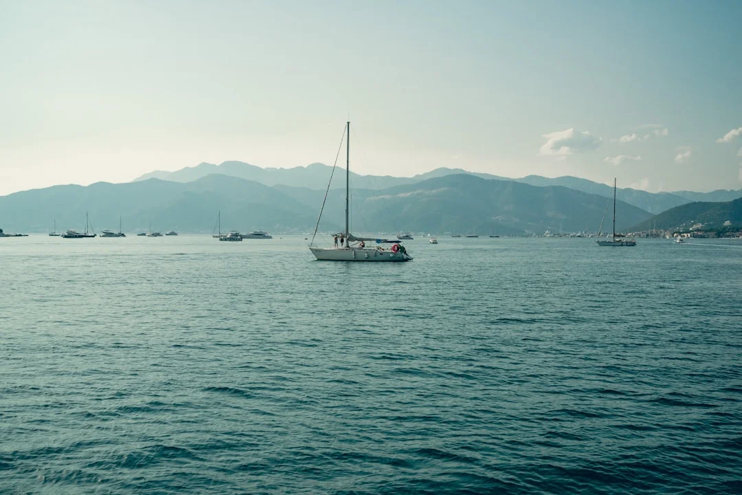 Crew picking up a mooring buoy with a boat hook in a crowded BVI mooring field