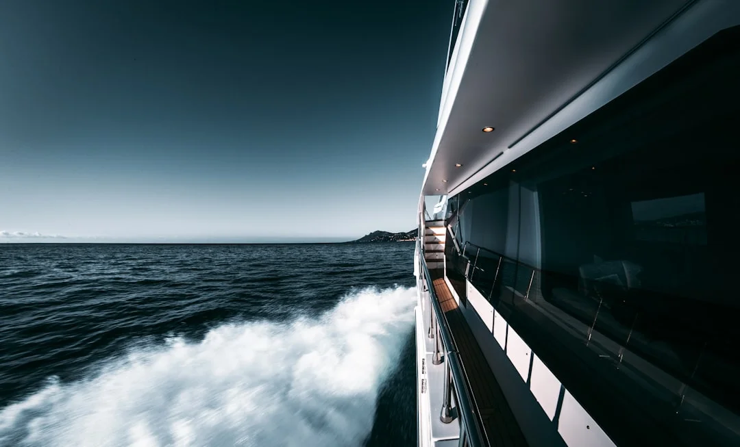 Trade-wind anchorage with catamarans on moorings, whitecaps outside the bay
