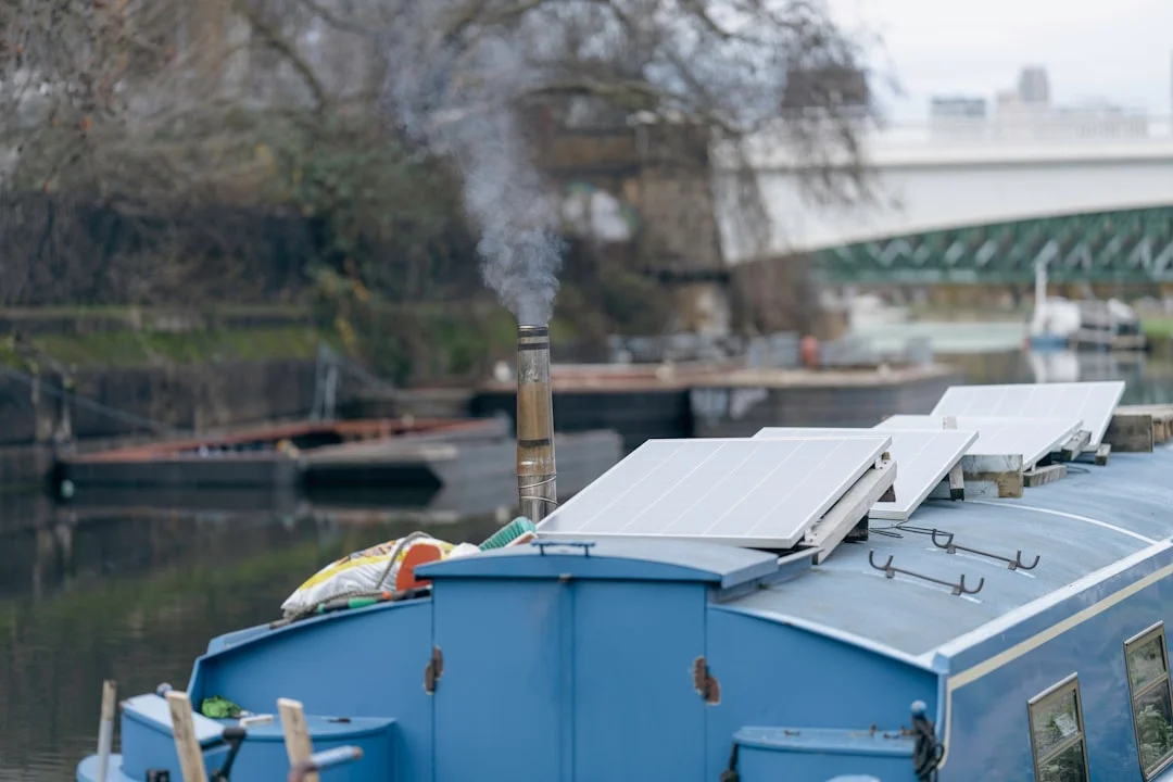 Close-up of diesel heater exhaust with insulation wrap, heat shield, and proper through-hull fitting