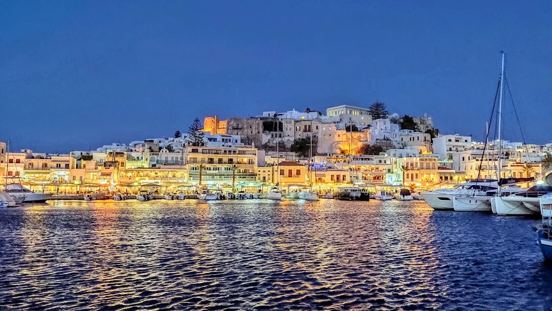 Calm Saronic anchorage with clear water and a stern-to quay in the background