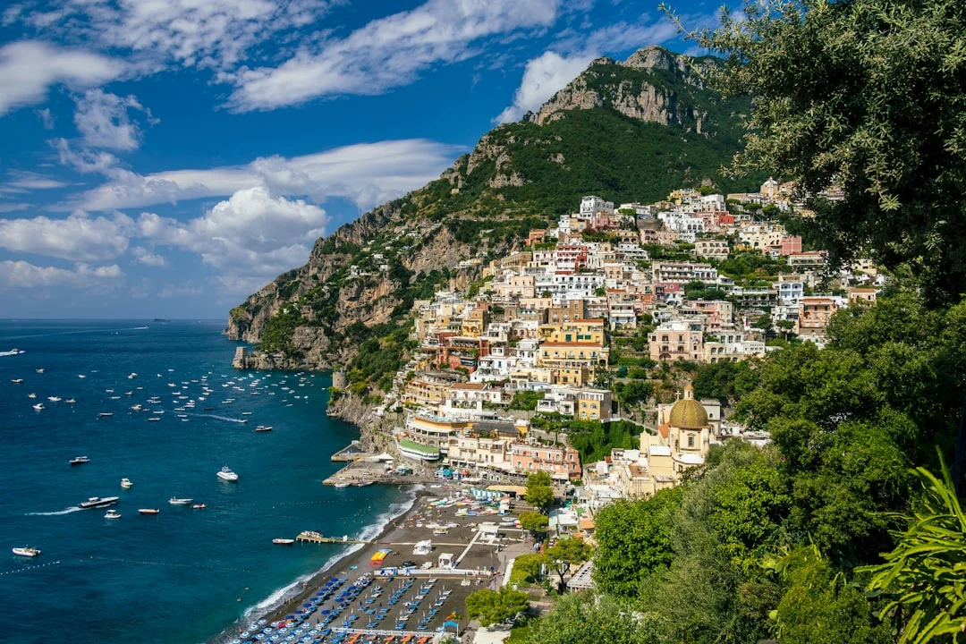 Positano roadstead showing mooring field and anchored yachts with steep hillside backdrop