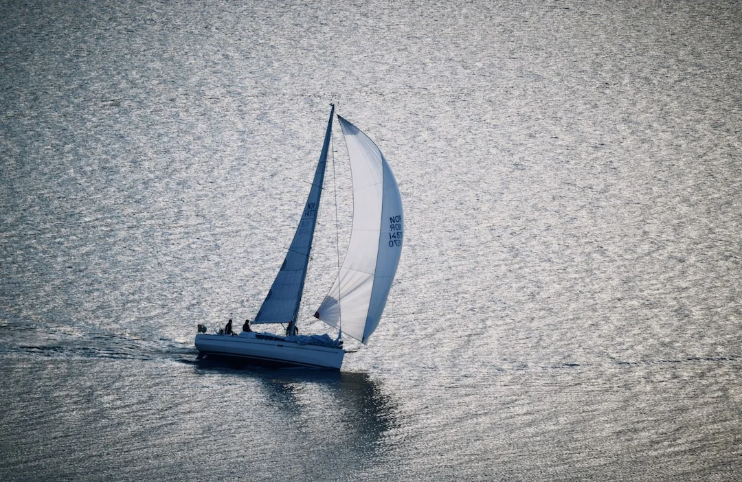 Wide-beam cruising catamaran approaching a floating dock with fenders set on both forward quarters