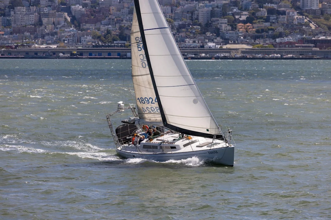 Sailboat reaching past Alcatraz with Angel Island in the background