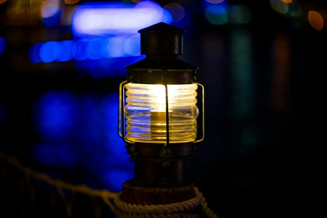Close-up of a modern IP67-rated masthead all-round LED fixture with sealed cable gland