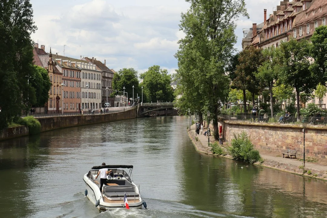 Vineyard-side canal reach in Burgundy with a hire boat moored at a rural bank